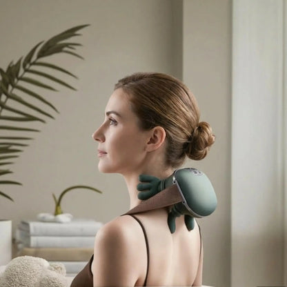 Woman using a neck and shoulder massager in a home setting